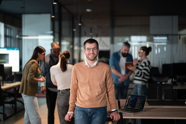 A successful business team working together in a modern startup office. Executives and employees collaborate, brainstorm, and showcase teamwork, leadership, and innovation in a confident, dynamic environment